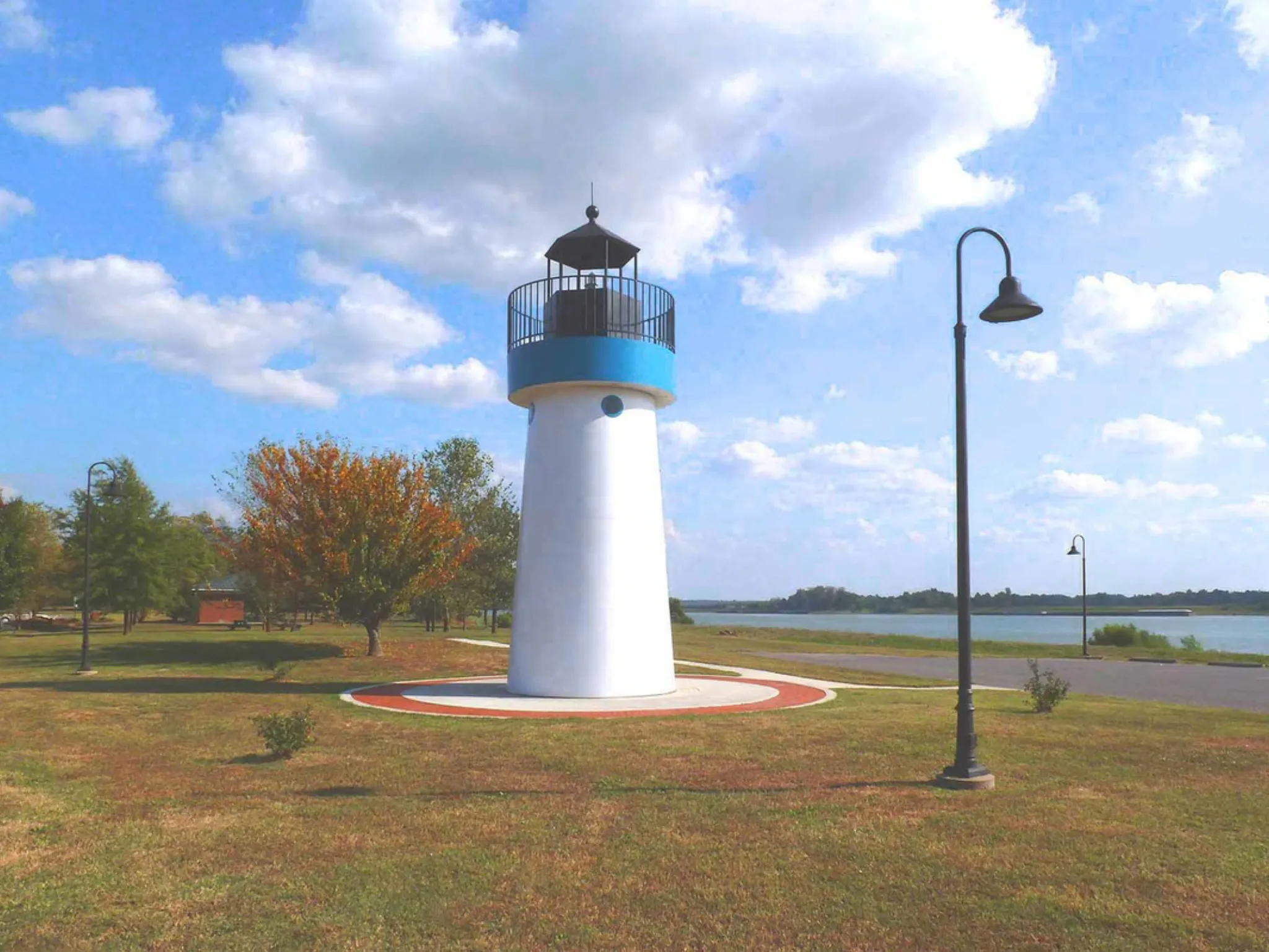 A grassy park with a path leading to a lighthouse