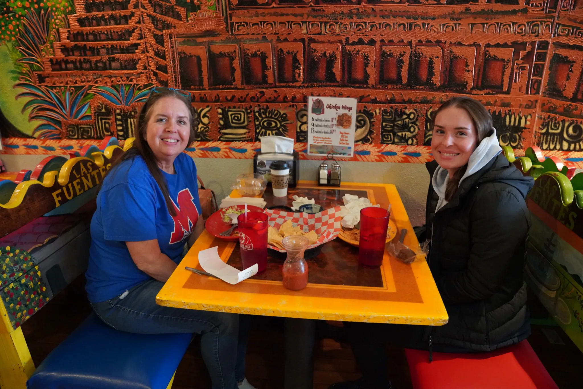 Two people dining in a booth at Las Fuentes in Metropolis